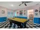 Fun game room featuring a billiards table and retro diner-themed decor, perfect for entertainment at 7618 Oakmoss Loop, Davenport, FL 33837