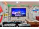 Spacious game room features movie theatre seating and fun murals at 7618 Oakmoss Loop, Davenport, FL 33837