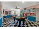 Spacious game room featuring a pool table, retro diner decor, and vintage-inspired wall art at 7618 Oakmoss Loop, Davenport, FL 33837