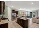 Well-lit kitchen with dark wood cabinets and granite countertops open to the living space at 7618 Oakmoss Loop, Davenport, FL 33837