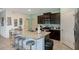 Modern kitchen with dark wood cabinets, granite countertops, and stainless steel appliances at 7618 Oakmoss Loop, Davenport, FL 33837