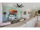 Bright, open living area with a comfortable sofa, television, and easy access to other living spaces at 7618 Oakmoss Loop, Davenport, FL 33837