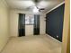 Spacious bedroom with neutral walls, a ceiling fan and natural light from the window at 7629 Chapelhill Dr, Orlando, FL 32819
