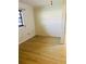 A clean and bright empty bedroom with wood-look floors, white walls, and a window with blinds at 7629 Chapelhill Dr, Orlando, FL 32819
