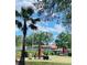 Charming community area with bocce court, benches, umbrellas and lush greenery, perfect for relaxing at 7629 Chapelhill Dr, Orlando, FL 32819