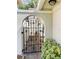 Charming arched gate leading to a private courtyard with brick pavers at 7629 Chapelhill Dr, Orlando, FL 32819