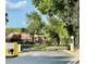 Gated entrance to the community with a security barrier and lush landscaping at 7629 Chapelhill Dr, Orlando, FL 32819
