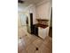 Kitchen with stainless steel refrigerator, custom cabinets, and tile flooring at 7629 Chapelhill Dr, Orlando, FL 32819