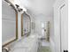 Bright bathroom featuring marble counters and a shower-tub combination with a colorful curtain at 901 Golfside Dr, Winter Park, FL 32792