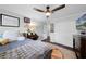 Cozy bedroom boasts ceiling fan, closet, wood floors, and a charming study nook at 901 Golfside Dr, Winter Park, FL 32792