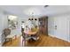 Well-lit dining room with hardwood floors, a wooden table, and a vintage display cabinet at 901 Golfside Dr, Winter Park, FL 32792