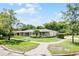 Corner lot featuring a charming brick house with a well-manicured lawn, pathway, and two-car garage at 901 Golfside Dr, Winter Park, FL 32792