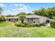Beautiful home showcasing the manicured lawn, trimmed bushes, and two-car garage, all under a bright blue sky at 901 Golfside Dr, Winter Park, FL 32792