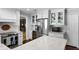 Bright kitchen featuring white cabinets, stainless steel appliances, hardwood floors, and a marble countertop at 901 Golfside Dr, Winter Park, FL 32792