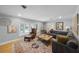 Cozy living room with a comfortable sectional sofa, a bay window with shutters, and a decorative rug at 901 Golfside Dr, Winter Park, FL 32792