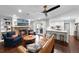 Comfortable living room with hardwood floors, a brick fireplace, a kitchen bar and a ceiling fan at 901 Golfside Dr, Winter Park, FL 32792