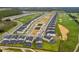 An aerial view showcases a community with manicured lawns, swimming pools, and a nearby golf course at 905 Ocean Course Ave, Davenport, FL 33896