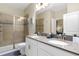 Elegant bathroom featuring a double sink vanity, sleek fixtures, and a glass-enclosed shower at 905 Ocean Course Ave, Davenport, FL 33896