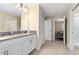 Bright bathroom featuring double sinks, white cabinetry and easy access to the bedroom and shower at 905 Ocean Course Ave, Davenport, FL 33896