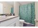 Bright bathroom with a patterned shower curtain, light countertop, and modern fixtures at 905 Ocean Course Ave, Davenport, FL 33896