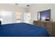 Relaxing primary bedroom boasts carpeted floors, a large window, and stylish furnishings at 905 Ocean Course Ave, Davenport, FL 33896