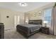 Cozy bedroom with neutral colors, a comfortable bed, and soft carpet flooring at 905 Ocean Course Ave, Davenport, FL 33896