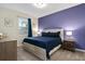 Comfortable bedroom with a cozy blue-themed decor, plush carpet, and a view through the window at 905 Ocean Course Ave, Davenport, FL 33896