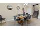 Elegant dining room with a wooden table, grey chairs, stylish mirrors, and ample natural light at 905 Ocean Course Ave, Davenport, FL 33896