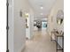 Inviting hallway featuring tile flooring, neutral walls, and views into adjacent living spaces at 905 Ocean Course Ave, Davenport, FL 33896