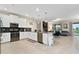 Bright kitchen with white cabinetry, stainless steel appliances, and an open view to the living room at 905 Ocean Course Ave, Davenport, FL 33896