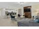 Open-concept living area with modern furnishings, a stylish kitchen, and a comfortable seating arrangement at 905 Ocean Course Ave, Davenport, FL 33896