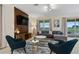 Comfortable living room with modern décor, a large window view, and stylish furnishings at 905 Ocean Course Ave, Davenport, FL 33896