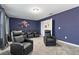 Spacious movie room with comfortable recliner seating, neutral carpet, and an oversized picture on the wall at 905 Ocean Course Ave, Davenport, FL 33896