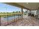 Inviting screened-in lanai with a pool, spa, brick pavers, and outdoor dining area at 905 Ocean Course Ave, Davenport, FL 33896