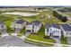 A view of the lovely new neighborhood, complete with modern homes, lush landscaping, and a serene pond at 905 Ocean Course Ave, Davenport, FL 33896