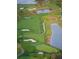 Aerial view of a meticulously designed golf course with ponds, sand traps, and winding fairways at 931 Croton Rd, Celebration, FL 34747