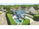 Beautiful blue home featuring a manicured backyard with pool, lounge area, and privacy hedge at 931 Croton Rd, Celebration, FL 34747