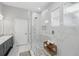 A luxurious bathroom featuring a glass-enclosed shower with marble tile and a modern vanity at 931 Croton Rd, Celebration, FL 34747