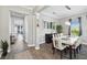 Elegant dining room featuring a modern chandelier, stylish furniture, and ample natural light at 931 Croton Rd, Celebration, FL 34747