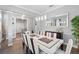Bright and airy dining area with an elegant table set for gatherings and a view into other living spaces at 931 Croton Rd, Celebration, FL 34747