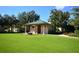 Exterior shot of building on a pristine green lawn with shade trees and a path at 931 Croton Rd, Celebration, FL 34747