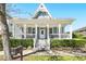 Inviting home with a charming front porch, decorative gable, and neatly trimmed hedges at 931 Croton Rd, Celebration, FL 34747