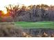 Scenic golf course view with a tranquil pond reflecting the sunset, creating a serene atmosphere for golfers at 931 Croton Rd, Celebration, FL 34747