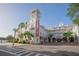 Exterior view of a charming hotel featuring a tower, balconies, and palm trees, radiating curb appeal at 931 Croton Rd, Celebration, FL 34747