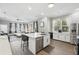 Open-concept kitchen with modern appliances, a central island, and a seamless flow into the living area at 931 Croton Rd, Celebration, FL 34747