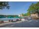 Picturesque lakeside view with seating areas, umbrellas, and a charming building in the background at 931 Croton Rd, Celebration, FL 34747