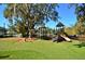 Playground featuring slides, climbing structures, and a soft, grassy ground cover at 931 Croton Rd, Celebration, FL 34747