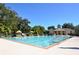 Large community pool with lounge chairs, umbrellas, and a clubhouse building, perfect for relaxation at 931 Croton Rd, Celebration, FL 34747
