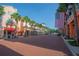 Picturesque street view with brick pavement, palm trees, and buildings adorned with American flags at 931 Croton Rd, Celebration, FL 34747