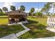 The backyard features a utility shed, a grilling station, and a lush green yard at 1060 Elkcam Blvd, Deltona, FL 32725